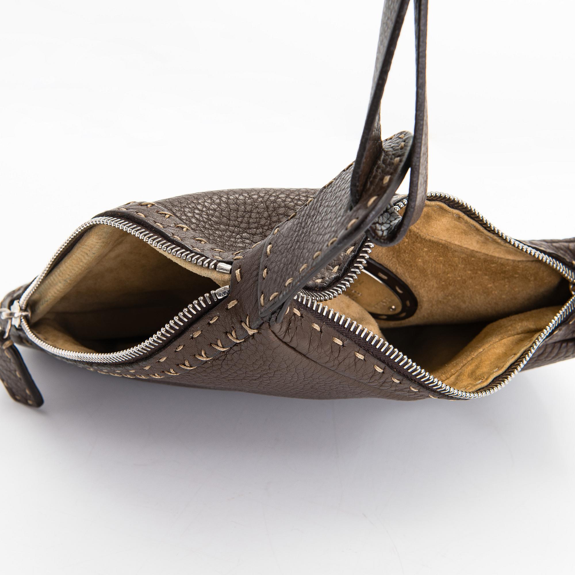 Fendi, a brown leather bag.