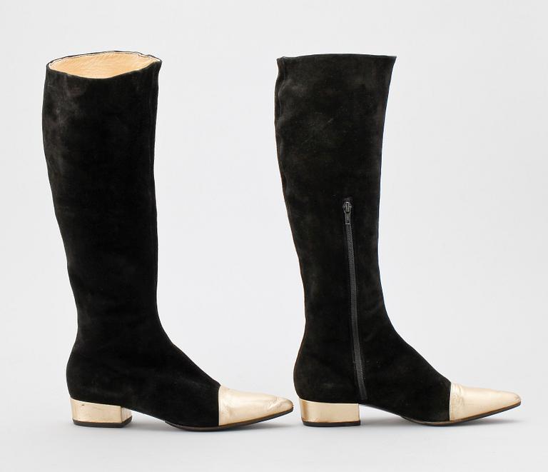 A pair of black suede boots by Versace.