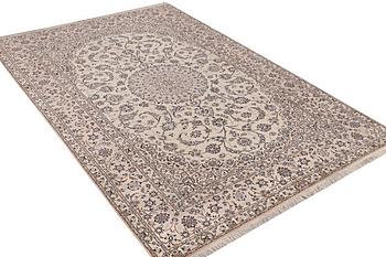 A carpet, nain, part silk, 6 laa, c. 316 x 210 cm.
