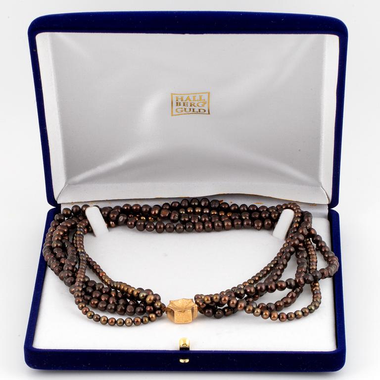 A five strand cultured pearl necklace.