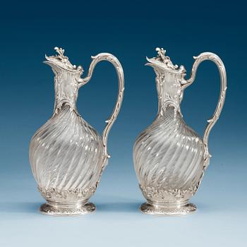 1002. A pair of French late 19th century silver and glass wine-flagons.