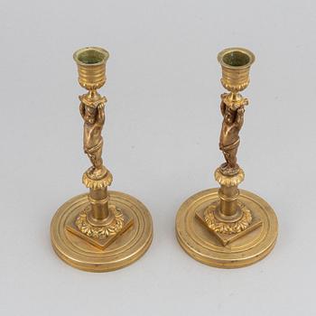 A pair of 19th Century bronze empire style candlesticks.