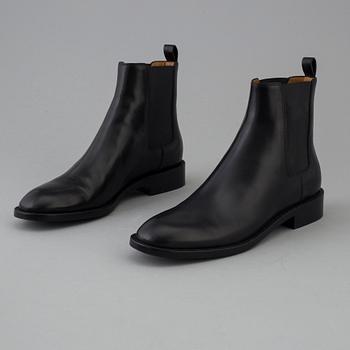 Black leather boots by Yves Saint Laurent.