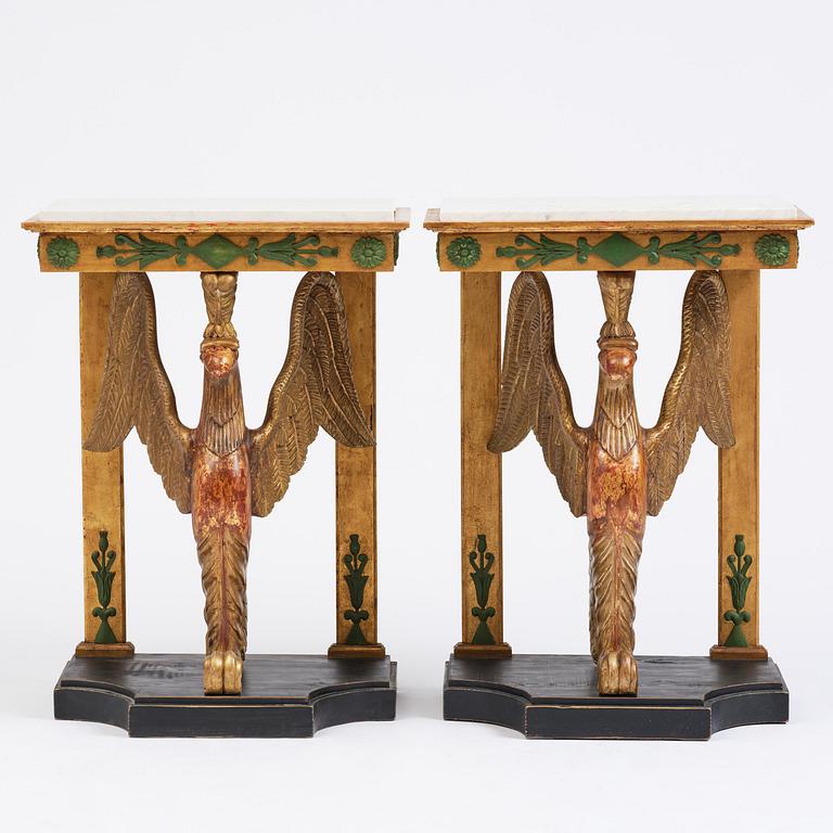 A pair of giltwood console tables, Empire-style incorporating older elements.