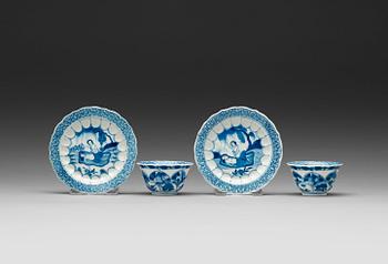 A pair of blue and white "erotic" cups with saucers, Qing dynasty Kangxi (1662-1722).