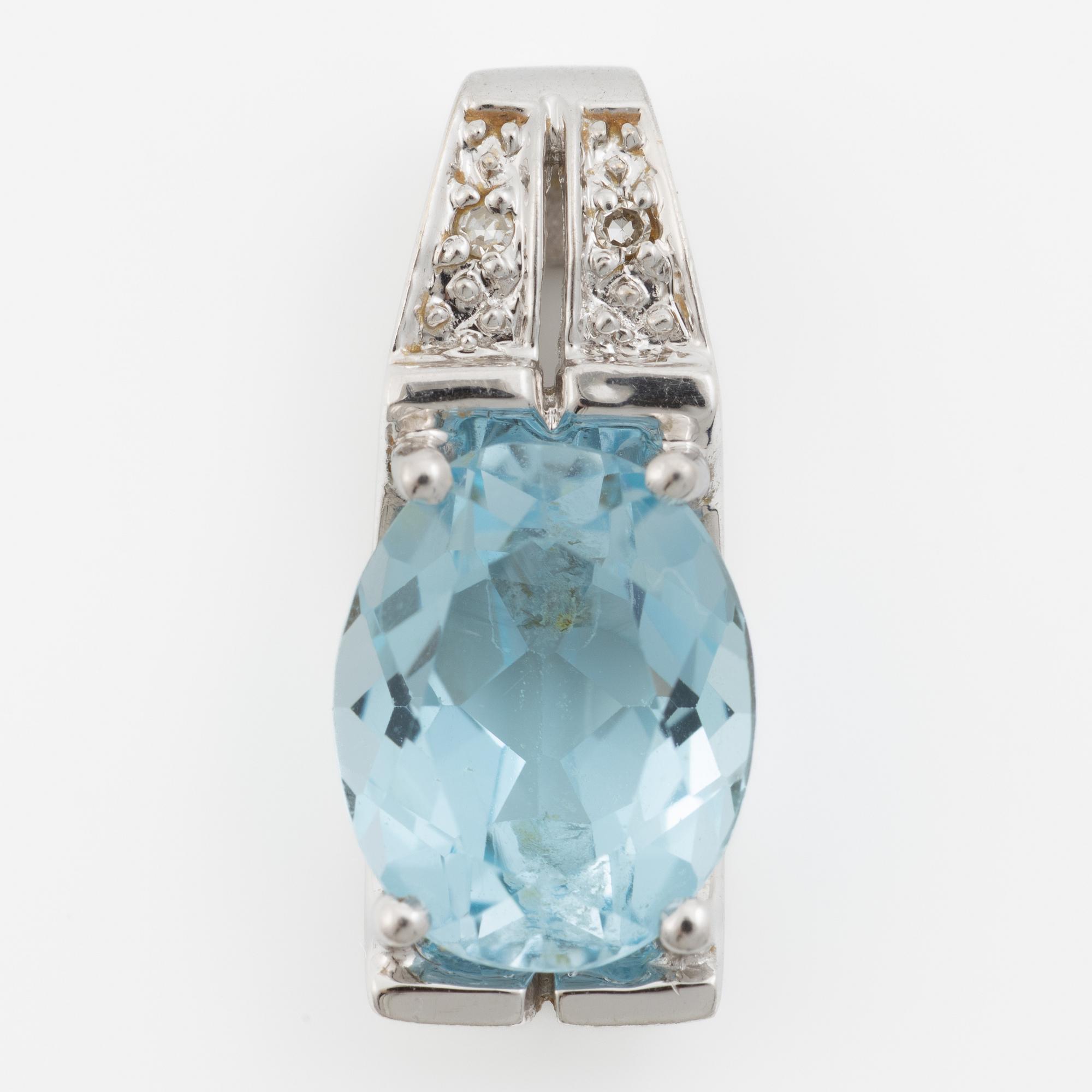 Pendant in 18K gold with a topaz and small diamonds.