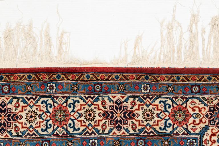 A carpet, semi-antique, Qum, ca 324 x 221 cm.