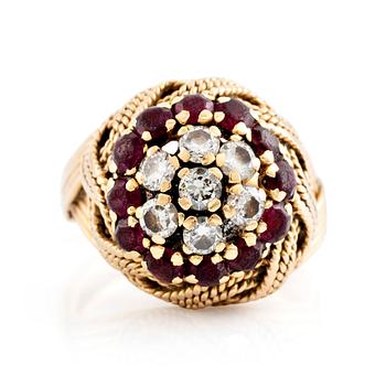 580. An 18K gold ring set with round brilliant-cut diamonds and rubies.