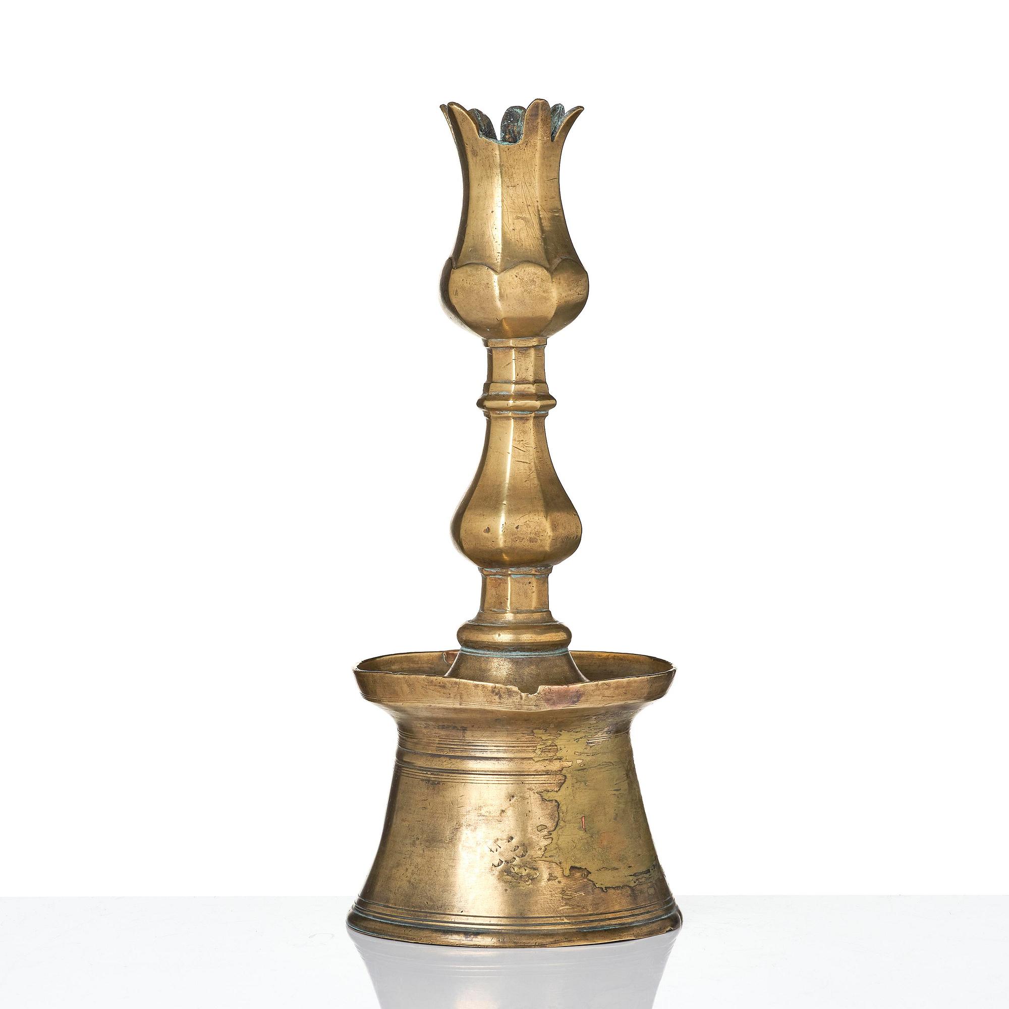 An Ottoman brass 'Tulip' Candelstick, Turkey, 17th/18th century.