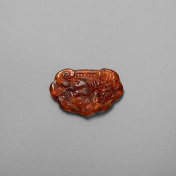 131. A carved Ruyi-shaped piece of Amber, early 20th Century.