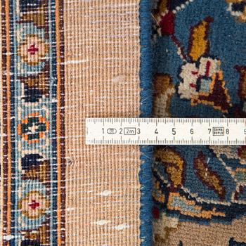 A carpet from Mashad, around 381 x 297 cm.