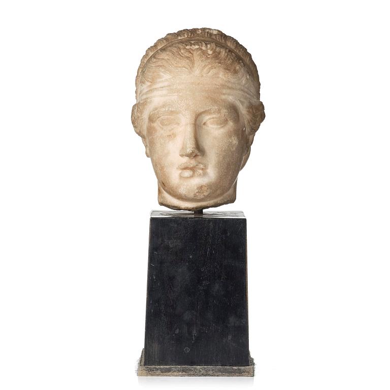 A Greek marble head of a deity wearing a Dionysiac fillet, Hellenistic style presumably 16th century.
