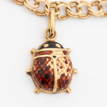 Bracelet, 18K gold bismarck link. With charms.