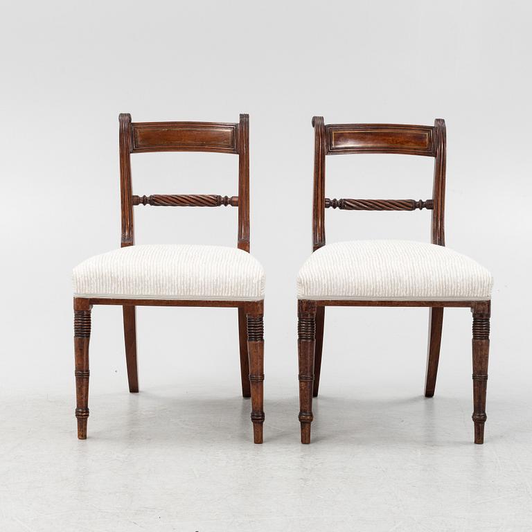 A set of 10 mahogany chairs and 2 armchairs, Regency style, from around the year 1900.