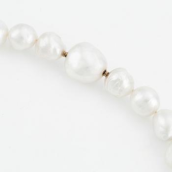 A Gaudy necklace with cultured South Sea pearls, a platinum bracelet, and two clasps.