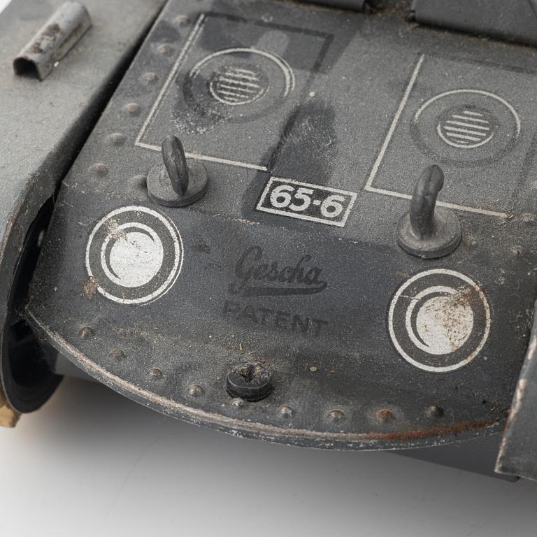 Three tin toys including a Gescha tank, Germany, mid 20th century.