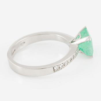 Platinum ring with an emerald and brilliant-cut diamonds.