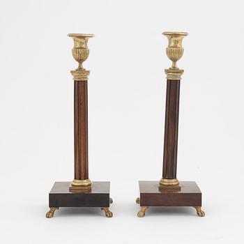 A pair of late Gustavian mahogany and brass candlesticks, circa 1800.