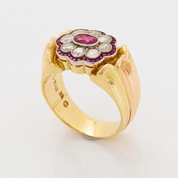 A WA Bolin ring in 18K gold set with rubies and round brilliant-cut diamonds.