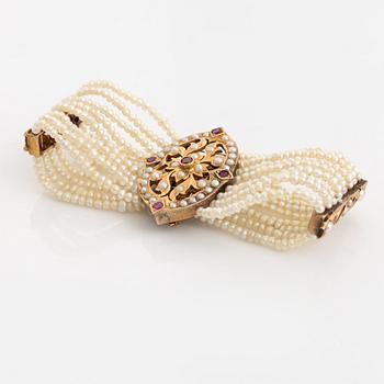 Bracelet, gold, eight-row with seed pearls and rubies.