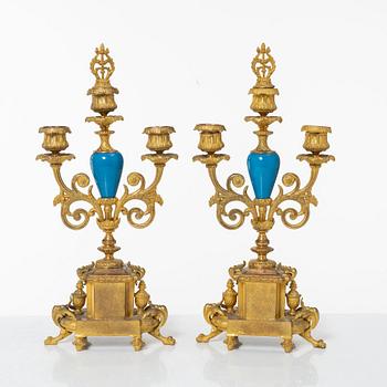 A French Louis XVI-style mantel clock and a pair of candelabra, late 19th Century.