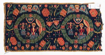 A carrige cushion, "Bebådelsen", tapestry weave, ca 95 x 47,5 cm, Skåne, 1800-1830.