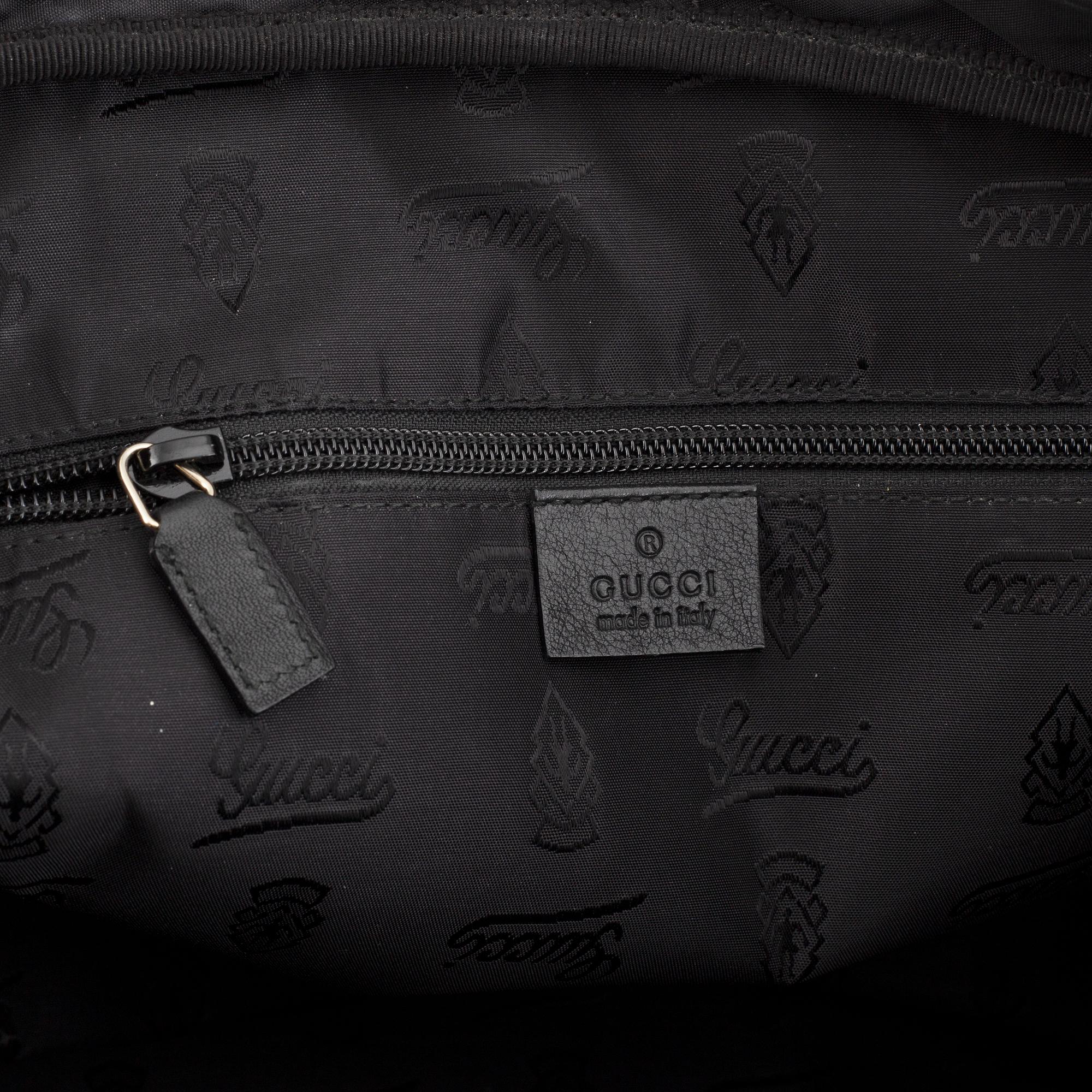 Gucci, a monogram leather bag/laptop-bag.