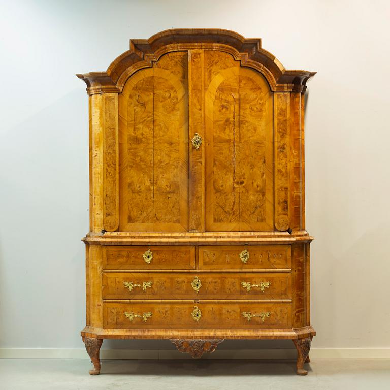 A Swedish elm and burr-elm rococo cabinet, later part of the 18th century.