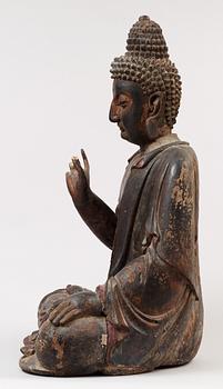 A Japanese partly lacquered wooden seated figure of Buddha, Edo (1603-1868).