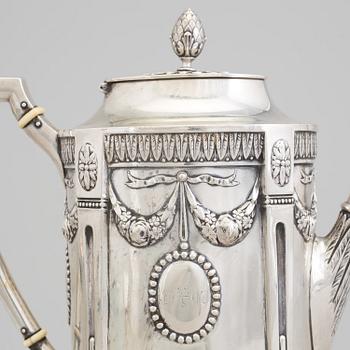 A set of three silver objects (coffeepot, creamer and sugarbowl, CG Hallberg and GAB, Stockholm 1907. Weight ca 1226 gr.