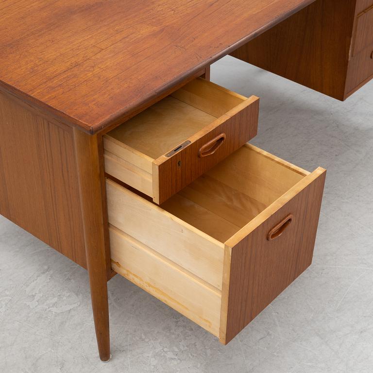 A teak veneered desk, 1950's/1960's.