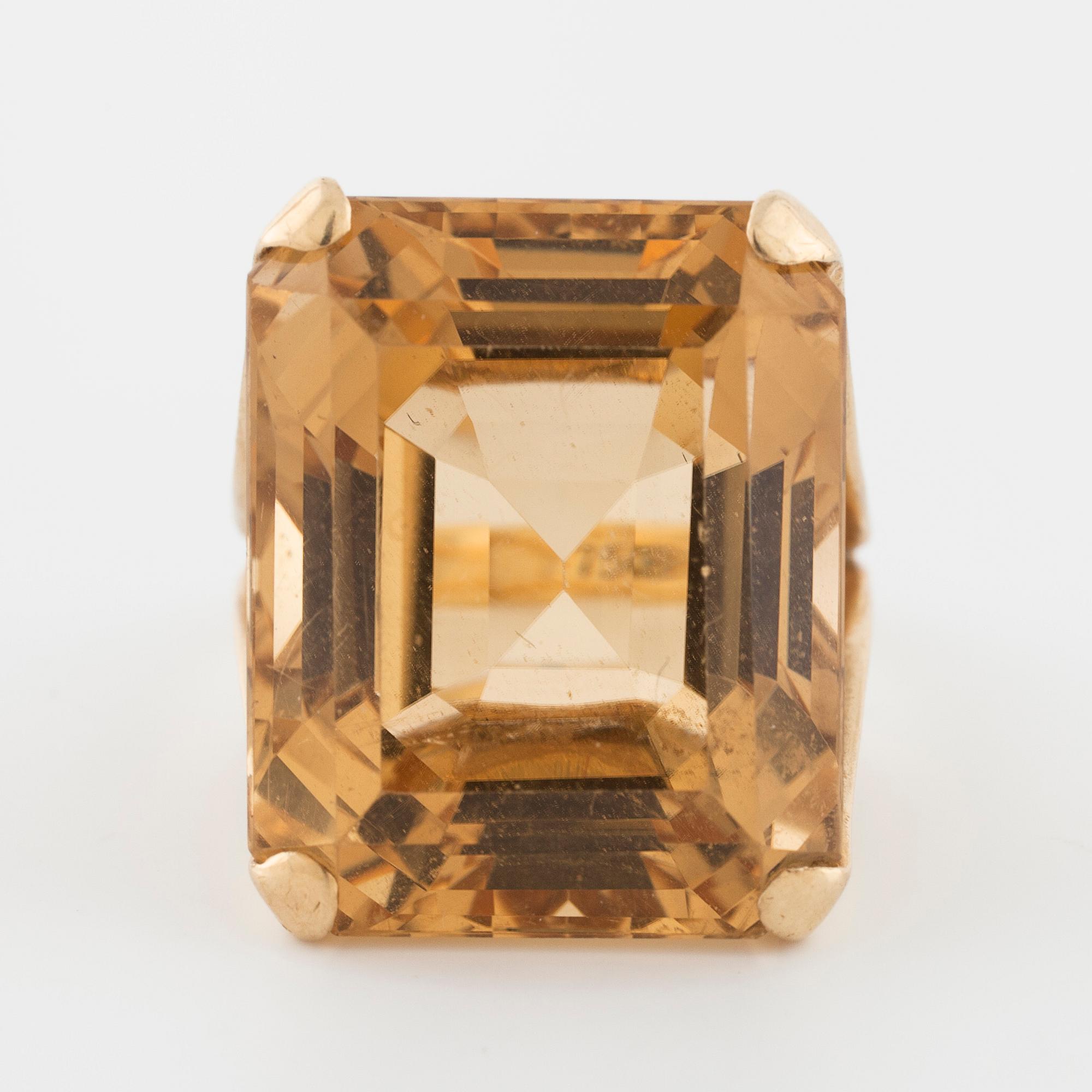 An emerald cut citrin ring.