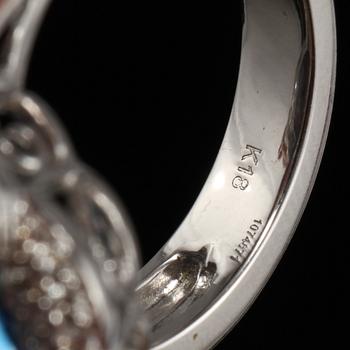 RING, 18k vitguld med checkerslipad blå topas, 2 fasettslipade akvamariner och 68 briljantslipade diamanter. Vikt 14g.