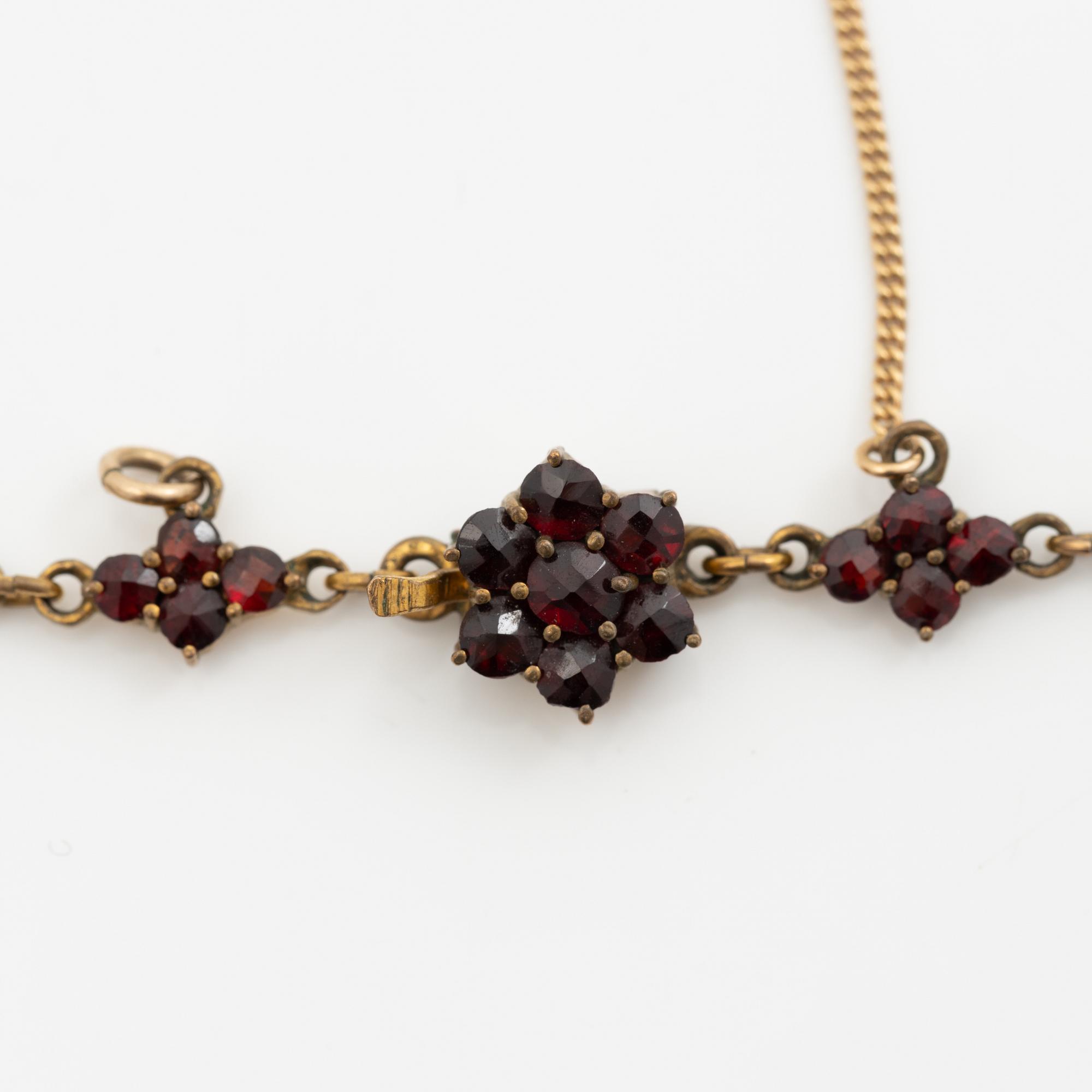 Pendant and a pair of earrings, gilt metal with garnets.