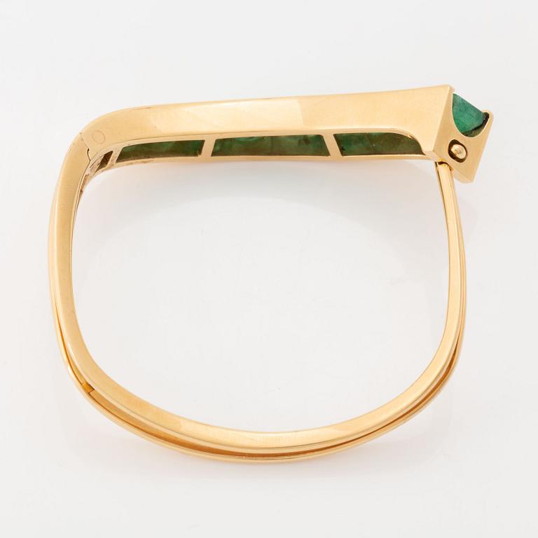 An 18K gold Lantz bracelet set with step-cut emeralds.