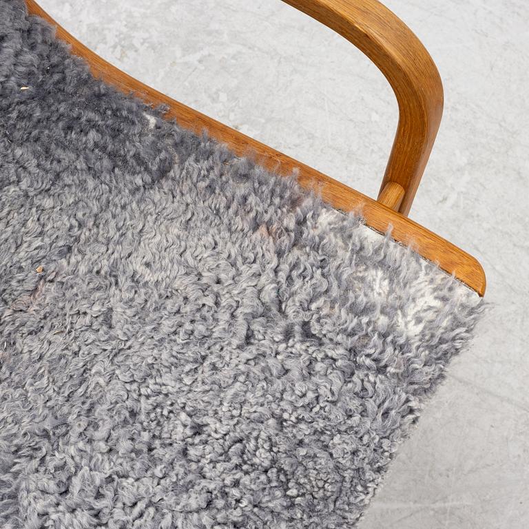 Yngve Ekström, a 'Lamino' armchair with ottoman, Swedese, Sweden, 2020's.