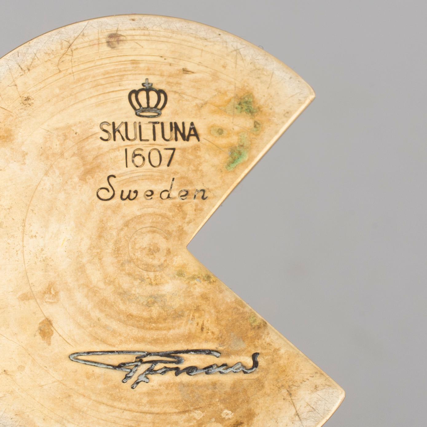 A brass candle holder by Pierre Forssell for Skultuna.
