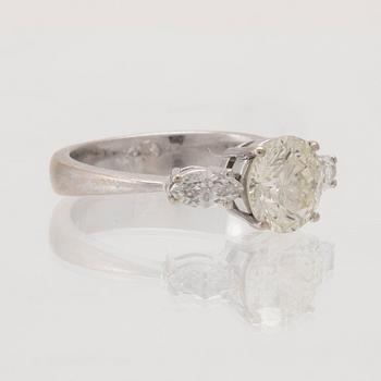 An 18K white gold ring set with one round brilliant-cut diamond and two marquise-cut diamonds.