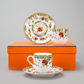 687. HERMÈS, a pair of porcelain coffecups with plates, "Le Jardin de Pythagore".