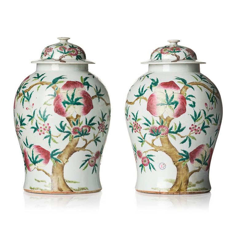 A pair of Chinese famille rose peach vases with covers, late Qing dynasty/circa 1900.