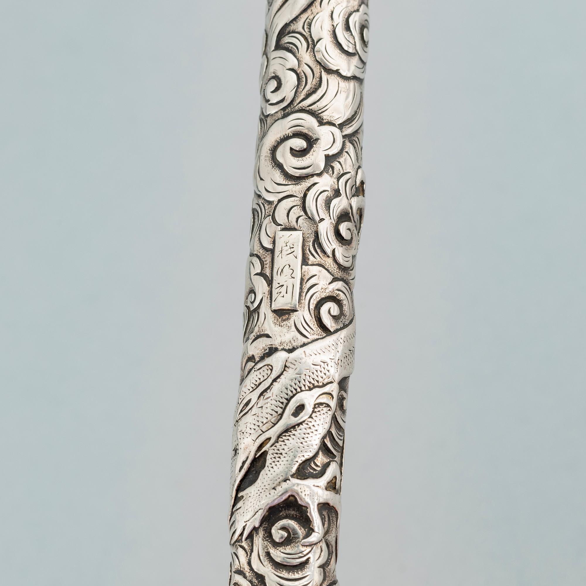 A Japanese silver opium pipe, Meiji period (1868-1912).