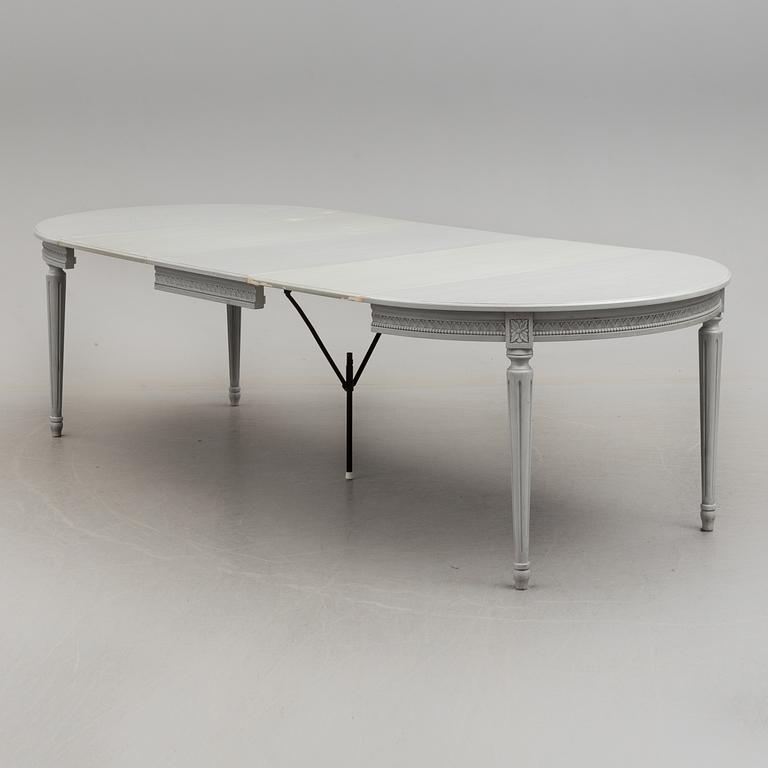 A Gustavian style dining table and ten chairs, 20th century.