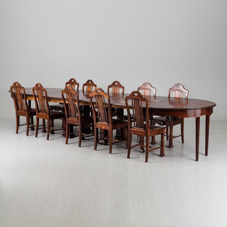 A late 19th century dining table with ten chairs and five extension leaves.