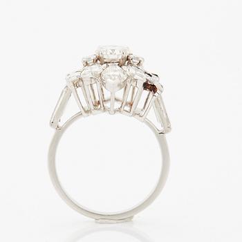 A platinum ring set with round brilliant-, navette- and baguette-cut diamonds.