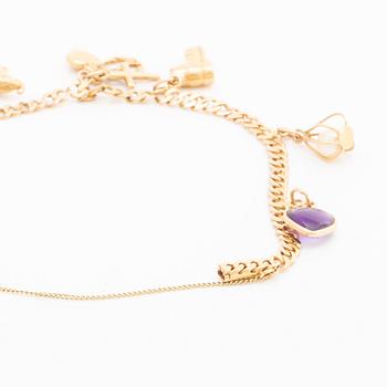 18K gold bracelet. With charms.