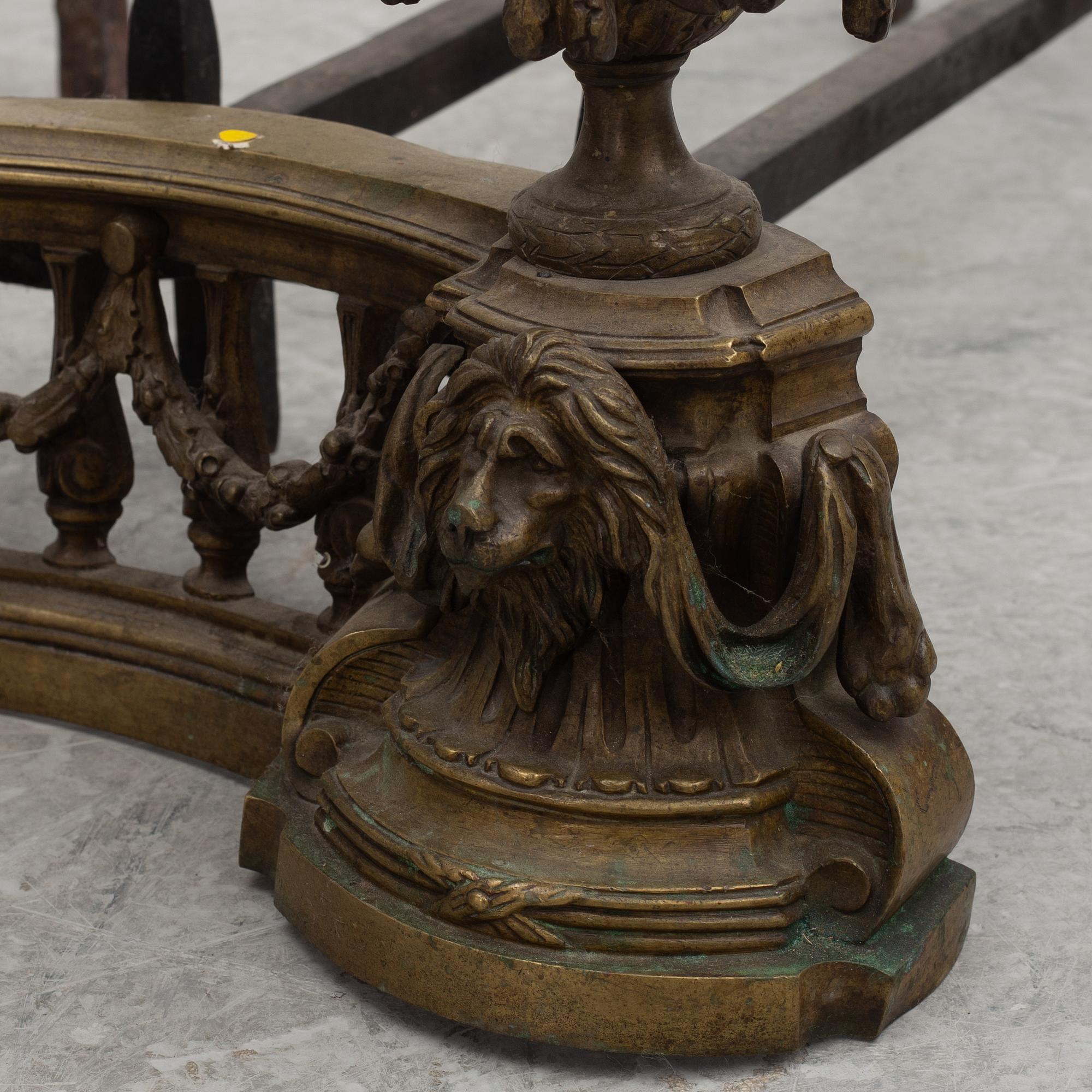A pair of brass and forged iron andirons, late 19th century.