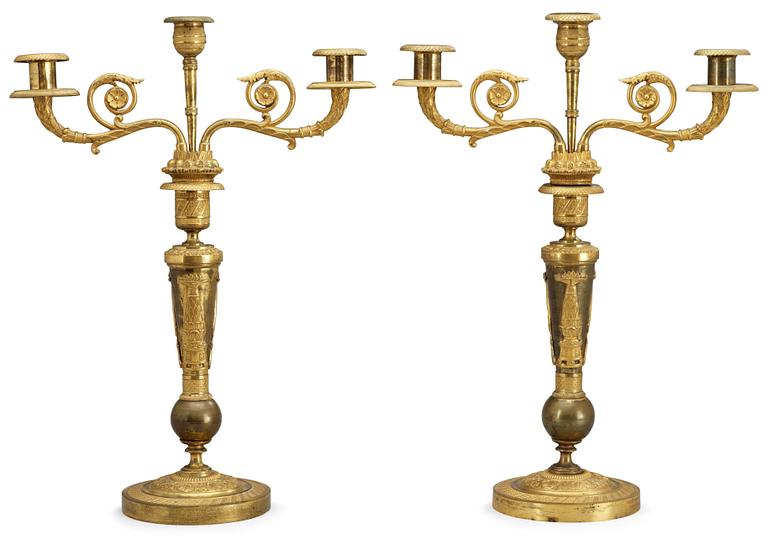 A pair of French Empire early 19th century three-light candelabra.