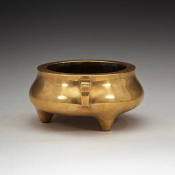 A polished bronze tripod censer, Ming dynasty (1368-1644).