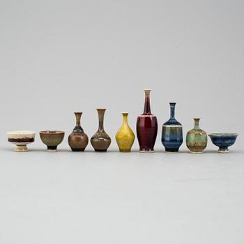 A mixed lot of glazed Höganäs ceramic miniture vases and bowls, four signed by John Andersson.