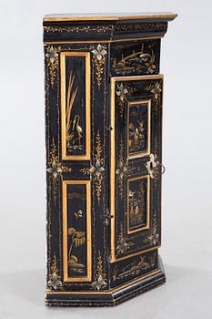 An 18th century corner cabinet.